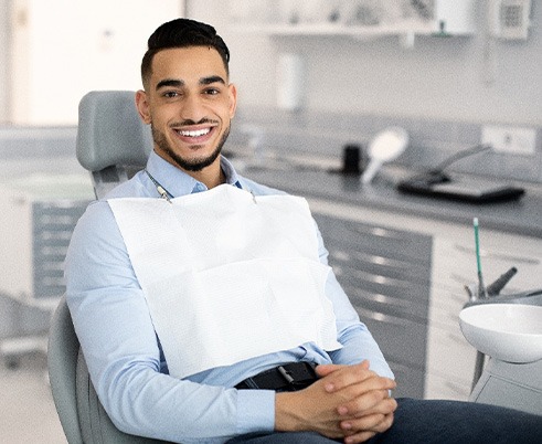 Patient smiling while sitting in treatment chair
