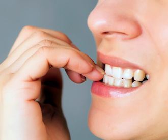 Closeup of patient biting their nails