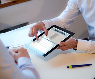 Patient reviewing dental insurance form on tablet