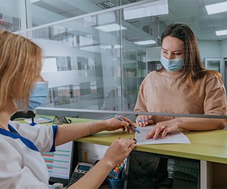 Patient in Houston filling out paperwork for financing tooth extractions