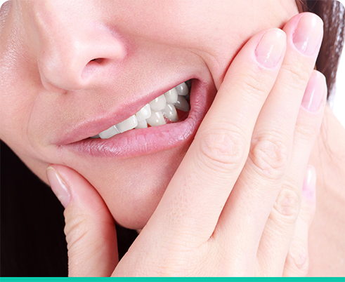 Close up of woman rubbing jaw in pain