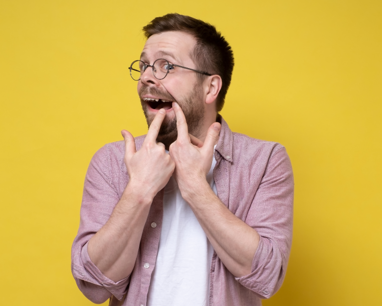 Man pointing at missing tooth