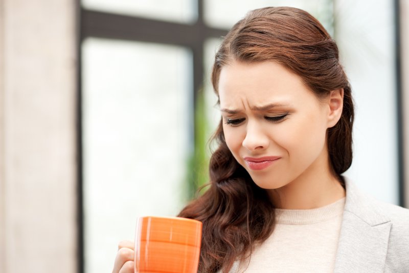 A young woman experiencing a bitter taste in her mouth